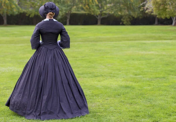 Victorian woman in black dress and bonnet