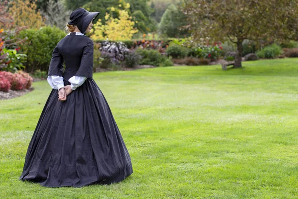 Victorian woman in black dress and bonnet