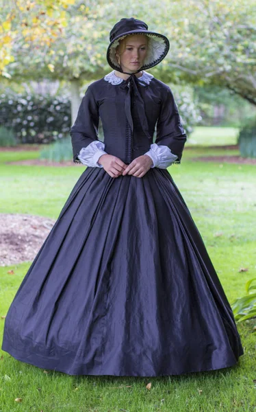 Victorian woman in black dress and bonnet