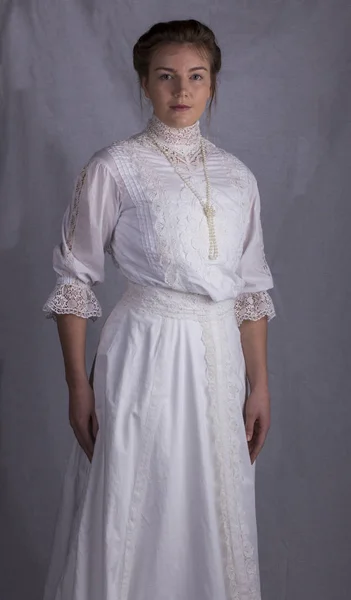 Edwardian woman wearing a white dress