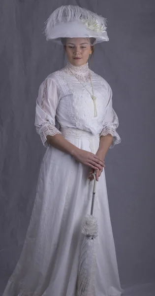 Edwardian woman wearing a white dress