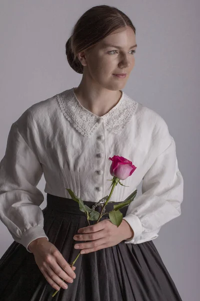 Victorian woman in white blouse and black skirt