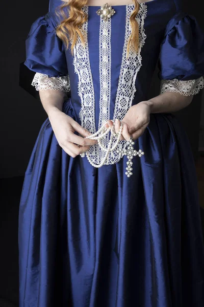 Renaissance woman in blue silk dress