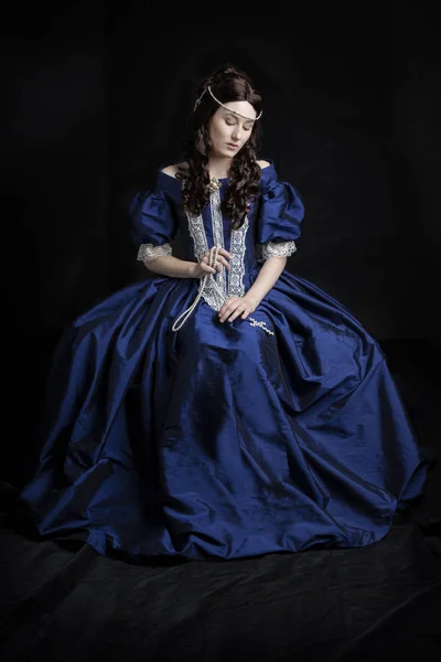 Renaissance woman in a blue silk dress