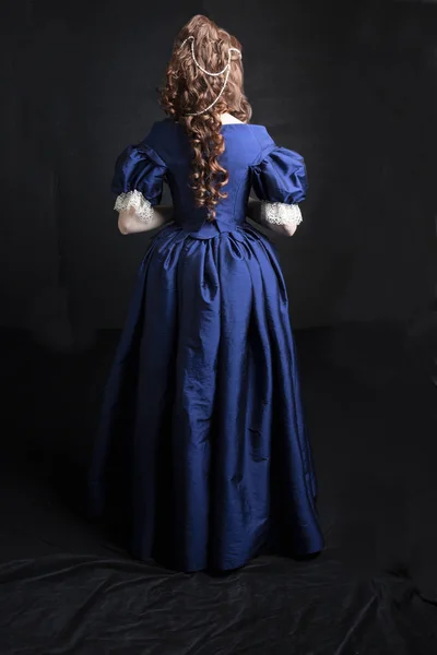 Renaissance woman in a blue silk dress