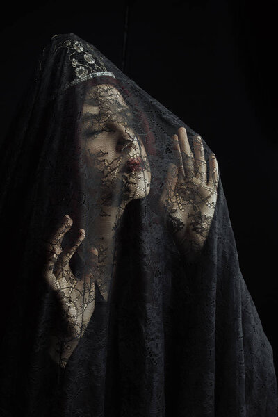 Spooky Victorian woman in a black ensemble