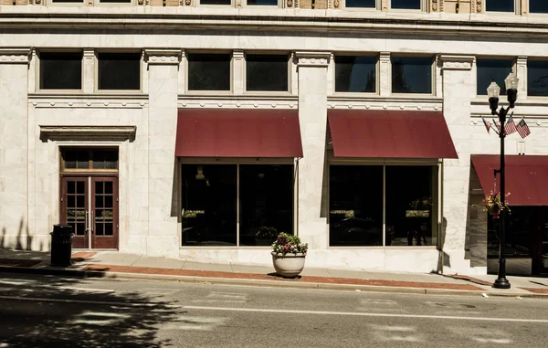 A store front alongside an empty street.