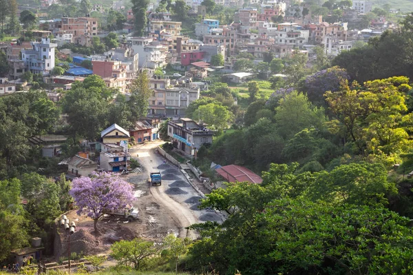 A high angle view of a road in a small town in the light of the setting sun in Nepal.