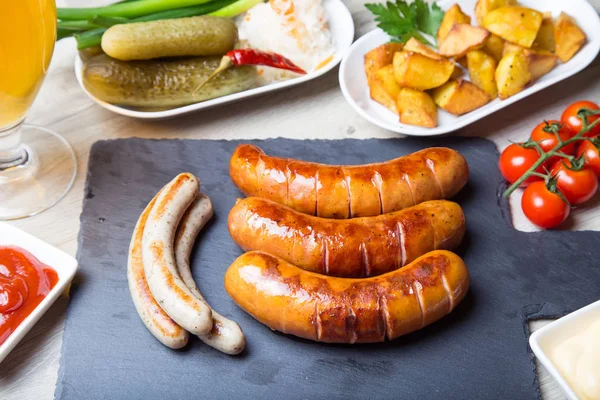 Grilled Sausages Potatoes Cucumbers Sauerkraut Two Sauces Close Selective Focus — Stock Photo, Image