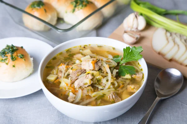 Shchi (cabbage soup) with buns (pampushki), fat and garlic. Traditional Russian and Ukrainian soup. Selective focus, close-up.