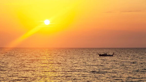 Boat with fishermen at sunset. Panorama.