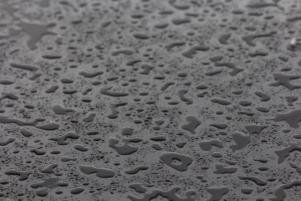Water drops and splashes on black background — Stock Photo, Image
