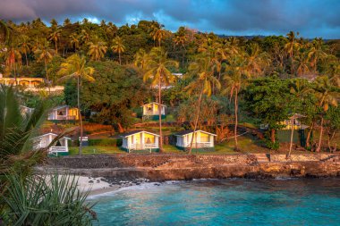 Sunset in holiday paradise resort on Grand Comore island, Comoros. Beautiful sunset light of sun going into the sea. Villas on the beach with private beach. Moroni Comoros, Itsandra beach resort hotel clipart