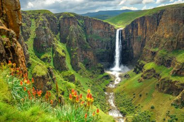 Maletsunyane Falls in Lesotho Africa. Most beautiful waterfall in the world. Green scenic landscape of amazing water fall dropping into a river inside canyons. Panoramic views over the great falls. clipart