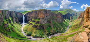 Maletsunyane Falls in Lesotho Africa. Most beautiful waterfall in the world. Green scenic landscape of amazing water fall dropping into a river inside canyons. Panoramic views over the great falls. clipart