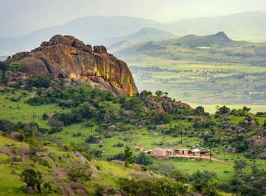 Ezulwini valley in Swaziland eSwatini with beautiful mountains, trees and rocks in scenic green valley between Mbabane and Manzini cities. Traditional huts houses of Swaziland clipart