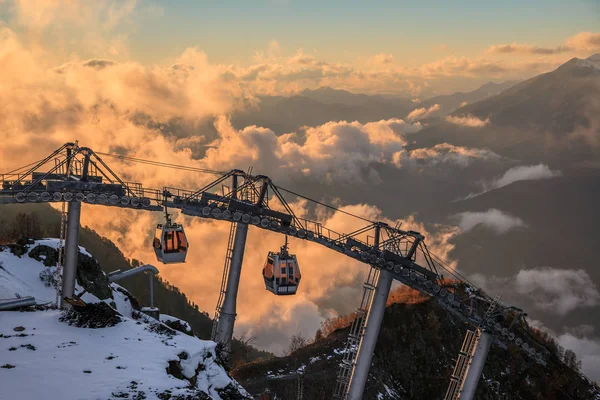 Cable car ski lifts in Gorky Gorod mountain ski resort can. Beautiful scenic sunset landscape. Sochi, Russia, Caucasus