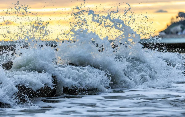 Surfing wave breaks with splashes and spindrift against water breaker during the storm on Black Sea coast — Stock Photo, Image