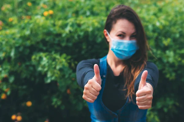 Young Woman Blue Medical Mask Rejoices End Quarantine Shows Her — Stock Photo, Image