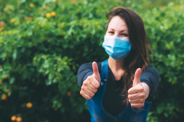 Young Woman Blue Medical Mask Rejoices End Quarantine Shows Her — Stock Photo, Image