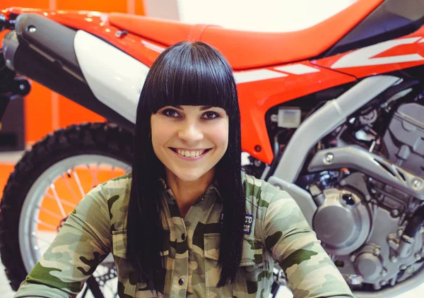 happy woman with motorcycle, sales department of motorcycles,
