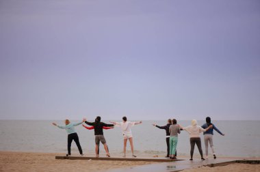 bir grup insan doğarken egzersizleri yapıyor karşılamak yoga, sağlıklı bir yaşam tarzı yaparken güneş,.