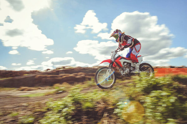 woman on enduro motocross in motion, desire for victory, dynamics of speed.