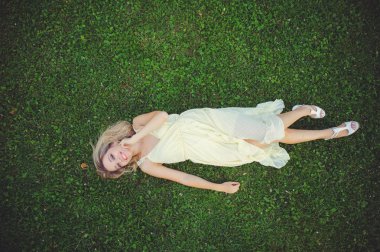 Güzel ve genç birbayan çim üzerinde yalan. Taze doğal yaz konsepti. Yukarıdan görüntüleyin. -görüntü