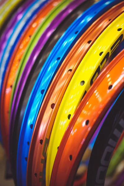 Продажа красивых цветных велосипедных ободков стоять в ряд различных цветов — стоковое фото