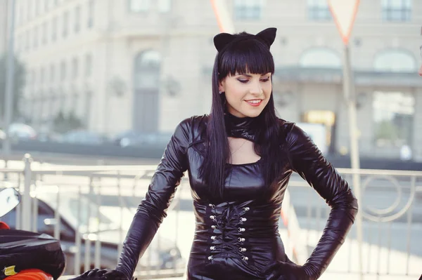 Costume of a beautiful young model wearing a cat costume. Hot sexy brunette cat-style female black fetish latex leather cat. Halloween