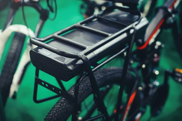 On the trunk is an electric bicycle battery, environmentally friendly technology. service and maintenance