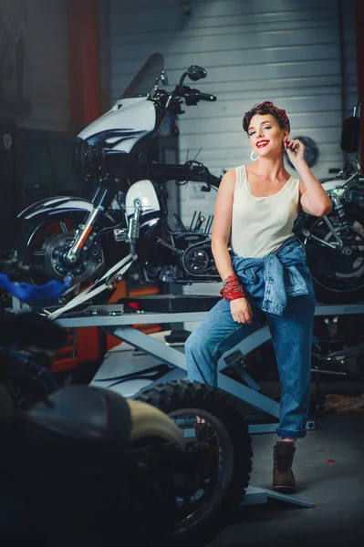 美しい女の子ポーズワークショップでオートバイを修理 ピンアップスタイル サービスと販売 — ストック写真