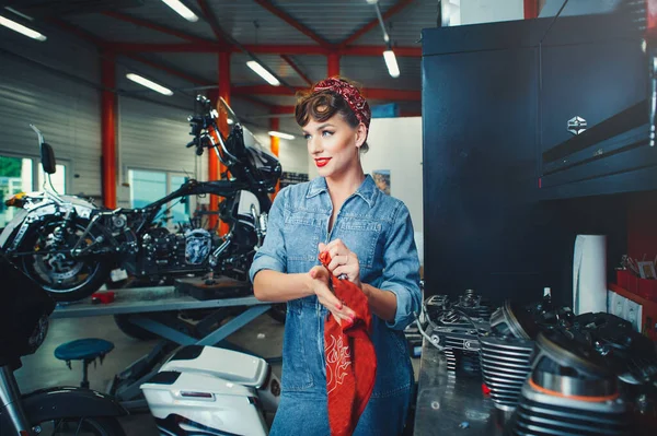 Beautiful motorcycle repair in the style of pin-up, service and sale. Women's Equality Profession