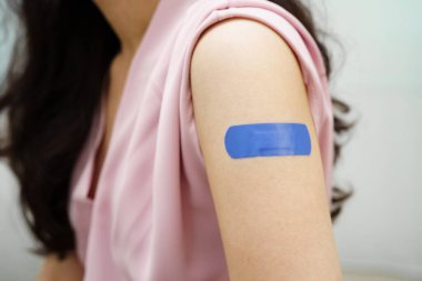 HPV, insan papilloma virüsü, mavi bandajlı aşı olan Asyalı genç kadın..