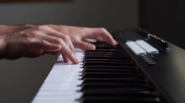 Stüdyoda MIDI klavye / MIDI denetleyici sentezleyici çalan müzisyen - elektronik müzik prodüksiyonu / kaydı için seçici-odaklı piyano tuşları yakın plan