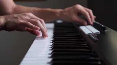 Stüdyoda MIDI klavye / MIDI denetleyici sentezleyici çalan müzisyen - elektronik müzik prodüksiyonu / kaydı için seçici-odaklı piyano tuşları yakın plan