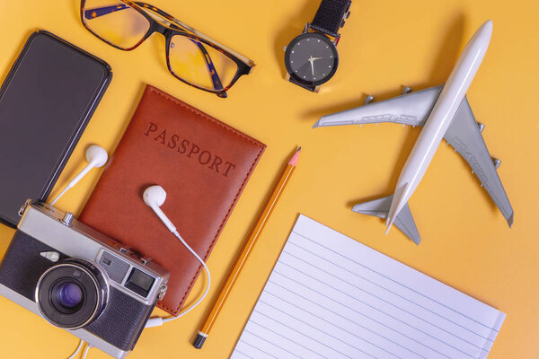 Luxury Travel objects flatlay on Yellow top view