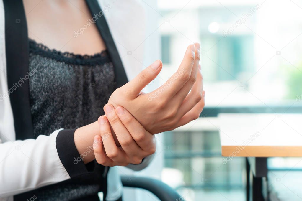 Female office worker is having office syndrome injury on her wrist