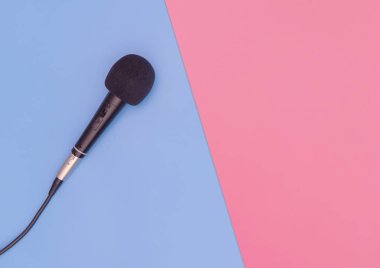 Mavi ve pembe kopyalama alanında siyah mikrofon