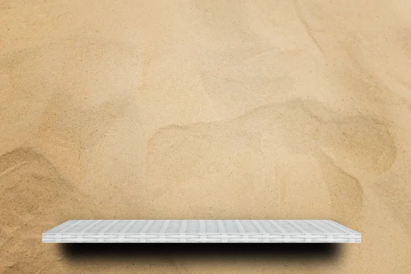 Empty white counter shelf on sand dune background