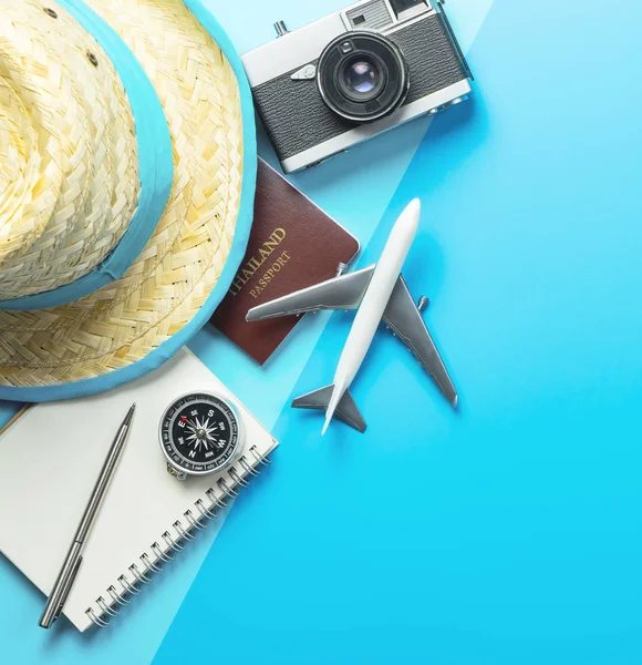 Summer travel blogger accesories on blue shading copy space