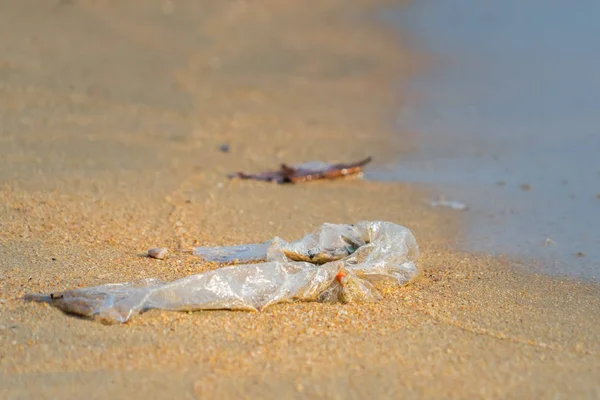 Plastic bag and pollution garbages on the beach — Stock Photo, Image