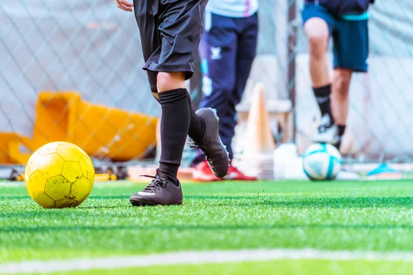 Kinderen trainen en dibbelen bal in voetbalopleiding — Stockfoto