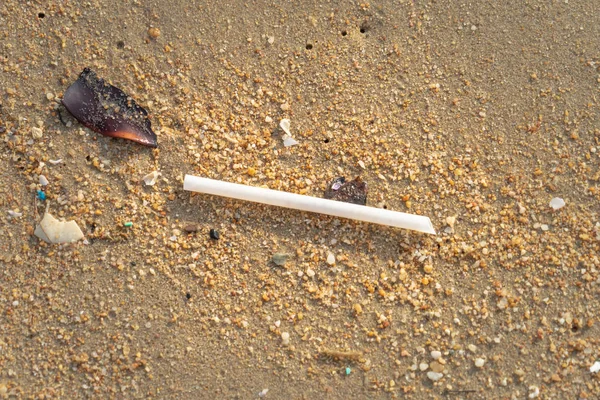 Plastic straw and pollution garbages on the beach