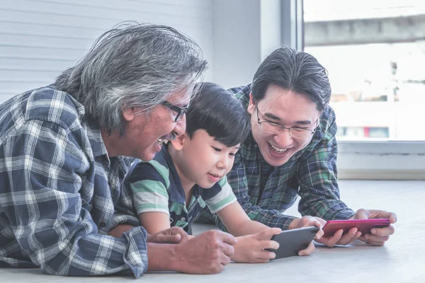 Happy Three generation of male is learning to use Mobile phone i