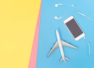 Müzik için mavi sarı pembe arka plan üzerinde cep telefonu ve uçak 