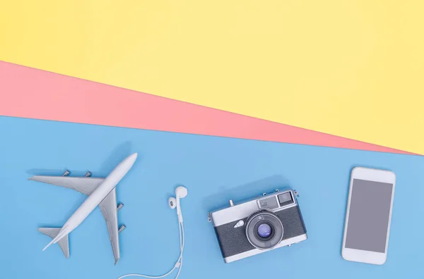 Travel accessories objects and gadgets top view flatlay on blue