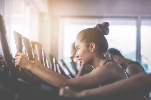 El grupo de mujeres activas está trabajando en bicicleta de fitness. — Foto de Stock