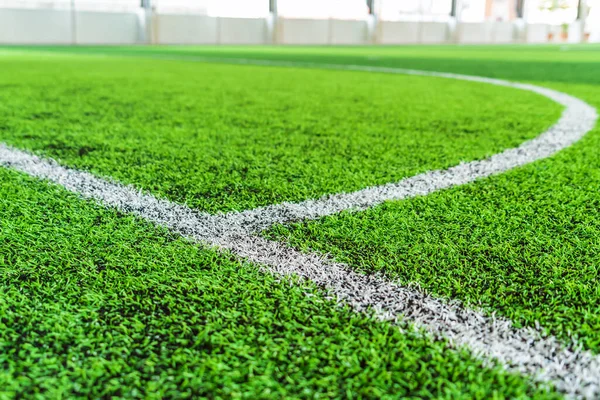 White round goal line on green grass for sport soccer field with nobody for background