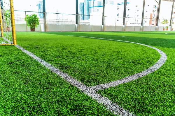 White round goal line on green grass for sport soccer field with nobody for background